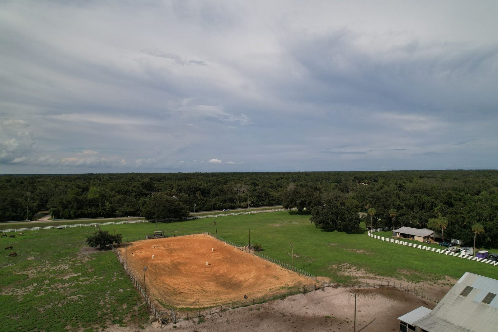 Aerial view of the riding arena and surrounding pasture at Timberlane Stables