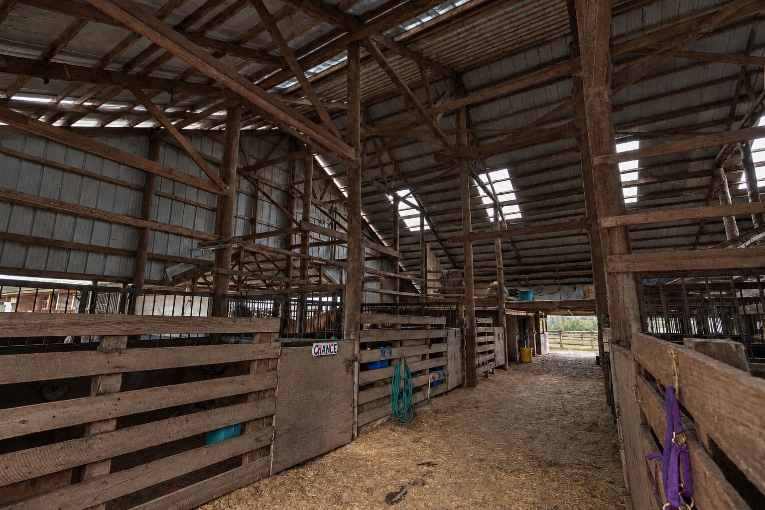 Barn aisle with a horse's name plate on its stall door at Timberlane Stables