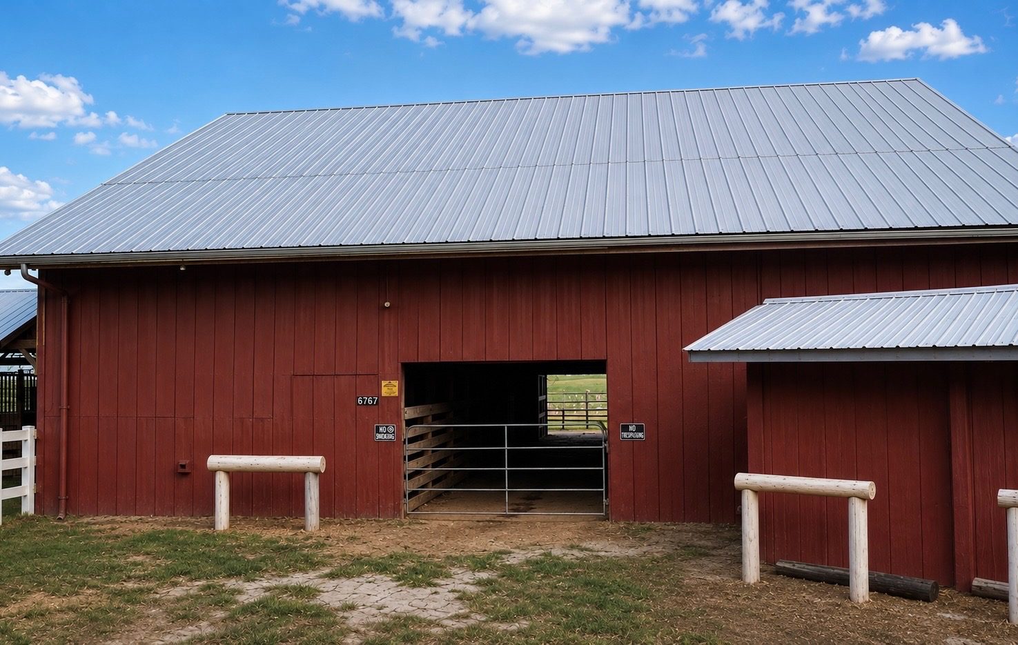 Timberlane Stables' red barn, with the property's street number over the entrance